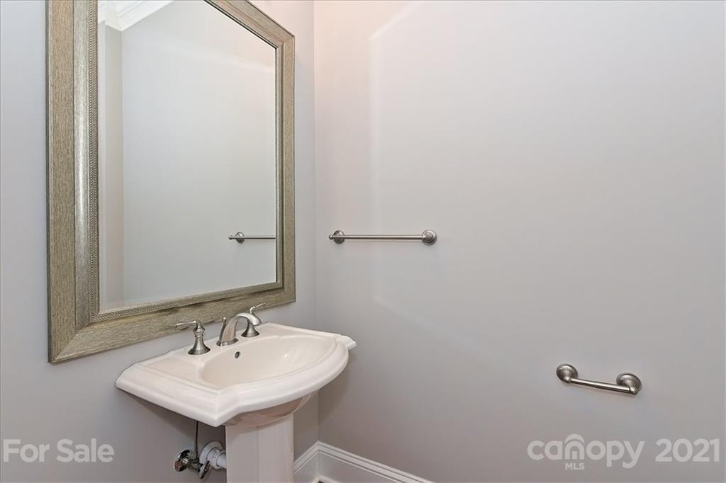 626 Queens Road, Unit 203 Charlotte, NC 28207 - Photo 32 of 48 a bathroom with a sink and a mirror