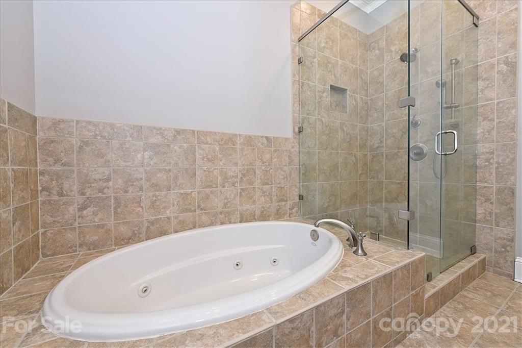 626 Queens Road, Unit 203 Charlotte, NC 28207 - Photo 38 of 48 a bathroom with a bathtub and shower