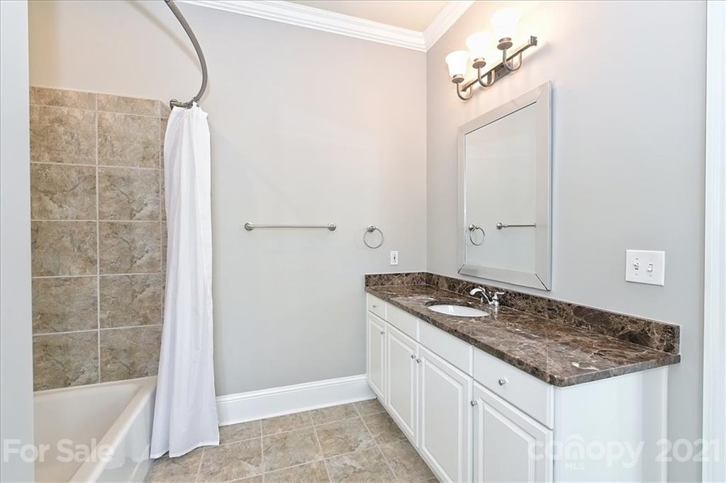 626 Queens Road, Unit 203 Charlotte, NC 28207 - Photo 42 of 48 a bathroom with a granite countertop sink and a mirror