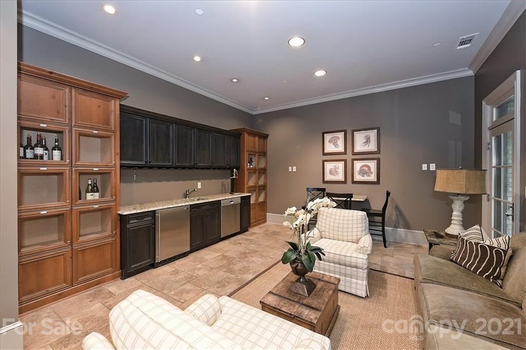 626 Queens Road, Unit 203 Charlotte, NC 28207 - Photo 5 of 48 a living room with stainless steel appliances furniture a rug and a kitchen view