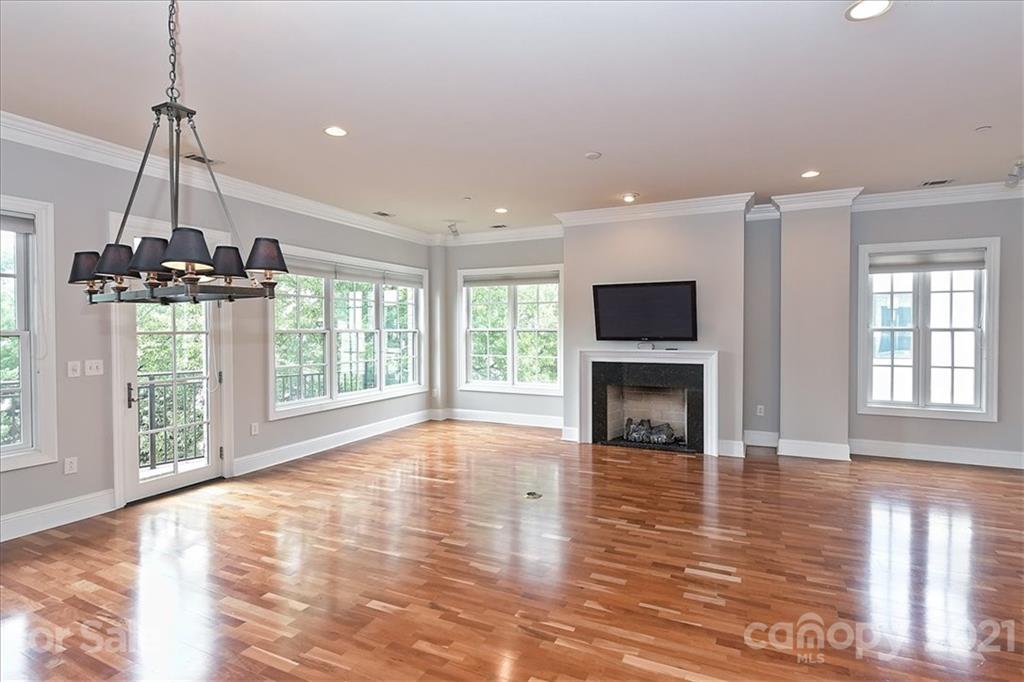 626 Queens Road, Unit 203 Charlotte, NC 28207 - Photo 9 of 48 a view of empty room with wooden floor and fireplace