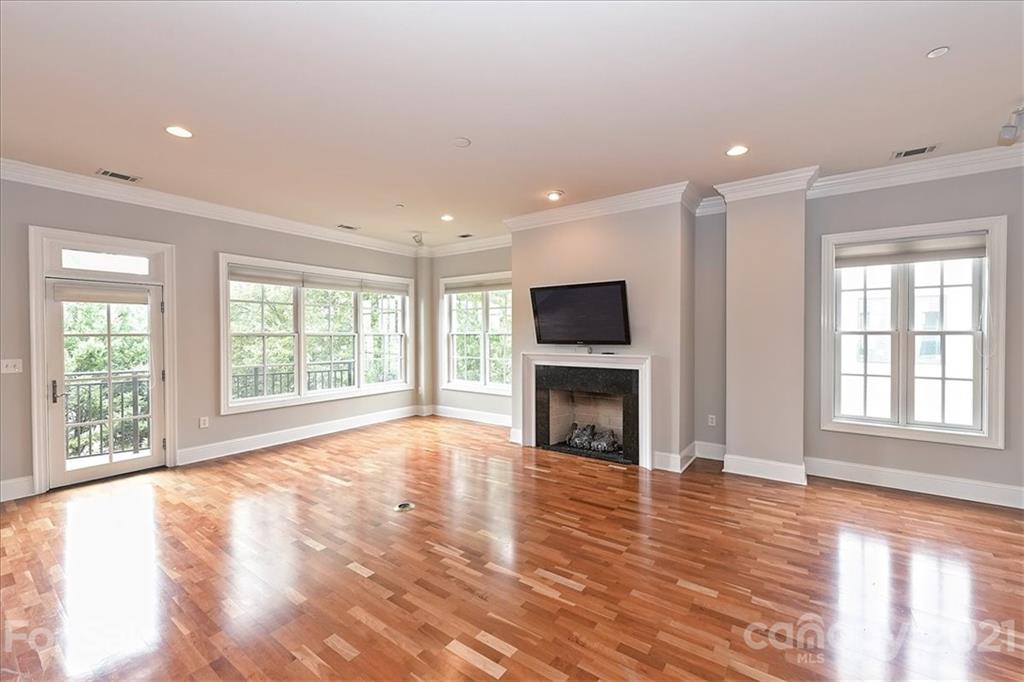626 Queens Road, Unit 203 Charlotte, NC 28207 - Photo 10 of 48 a view of empty room with fireplace and wooden floor