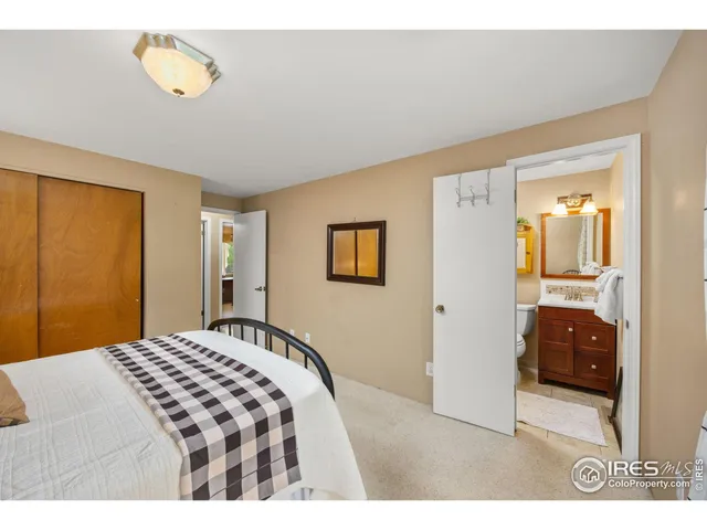 a bedroom with a bed and a lamp