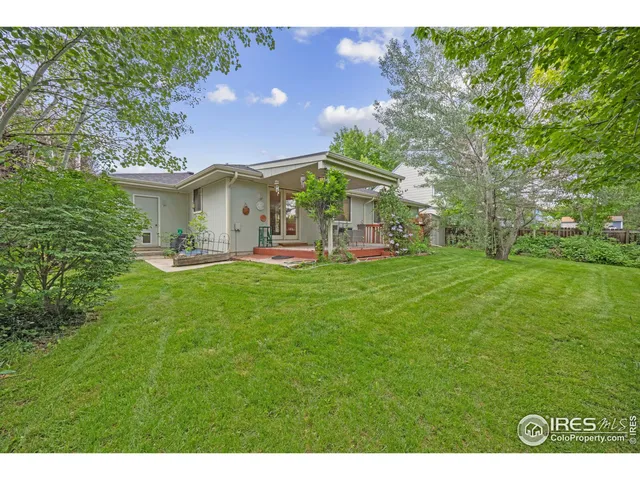a view of backyard of house with green space