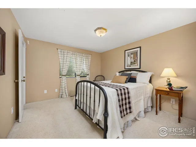 a bedroom with a bed and a night stand