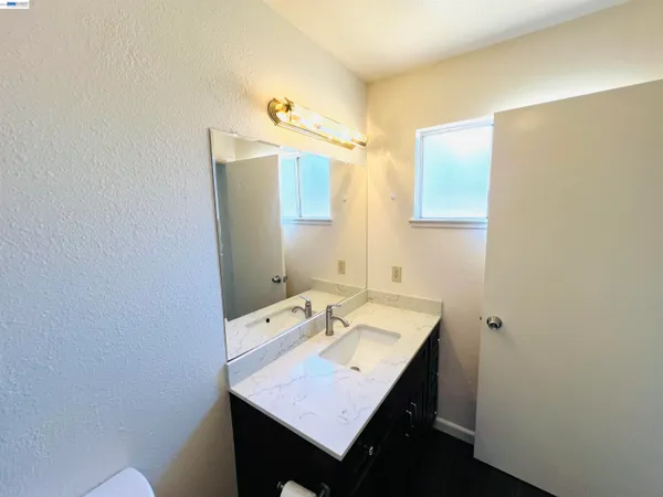 a bathroom with a sink a mirror and a toilet