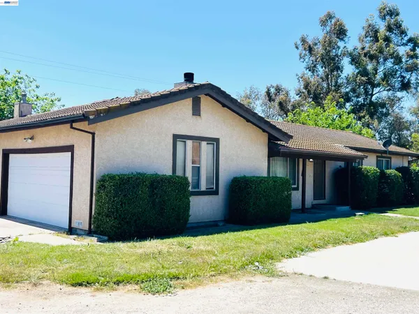a house that has a tree in front of it