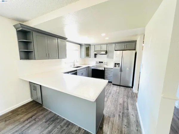 a kitchen with stainless steel appliances a refrigerator and a stove