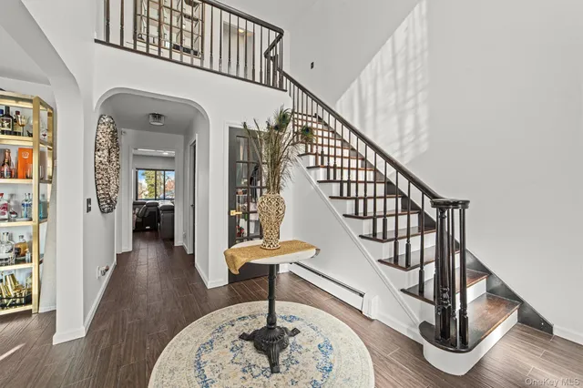 a view of entryway and hall with wooden floor