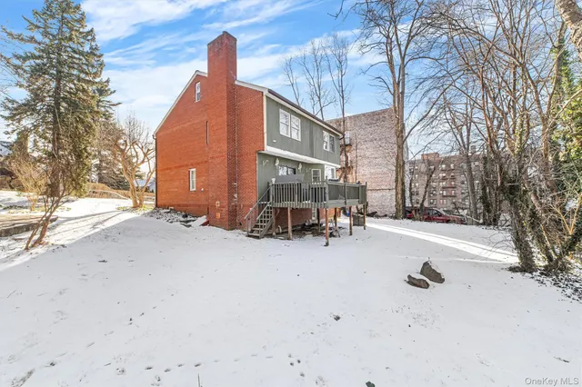 a wooden bench sitting in front of a building