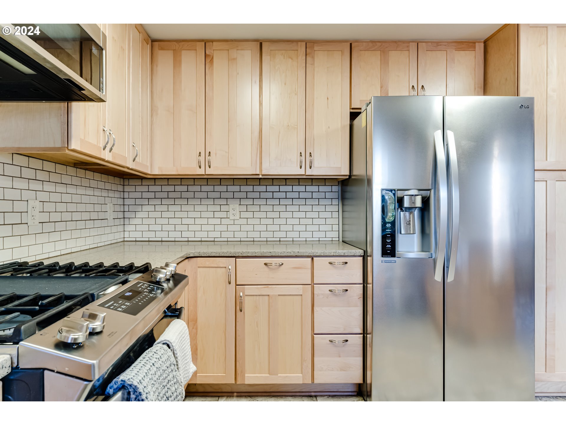 686 South 69th Place Springfield, OR 97478 - Photo 12 of 38 a kitchen with stainless steel appliances granite countertop a refrigerator and a stove