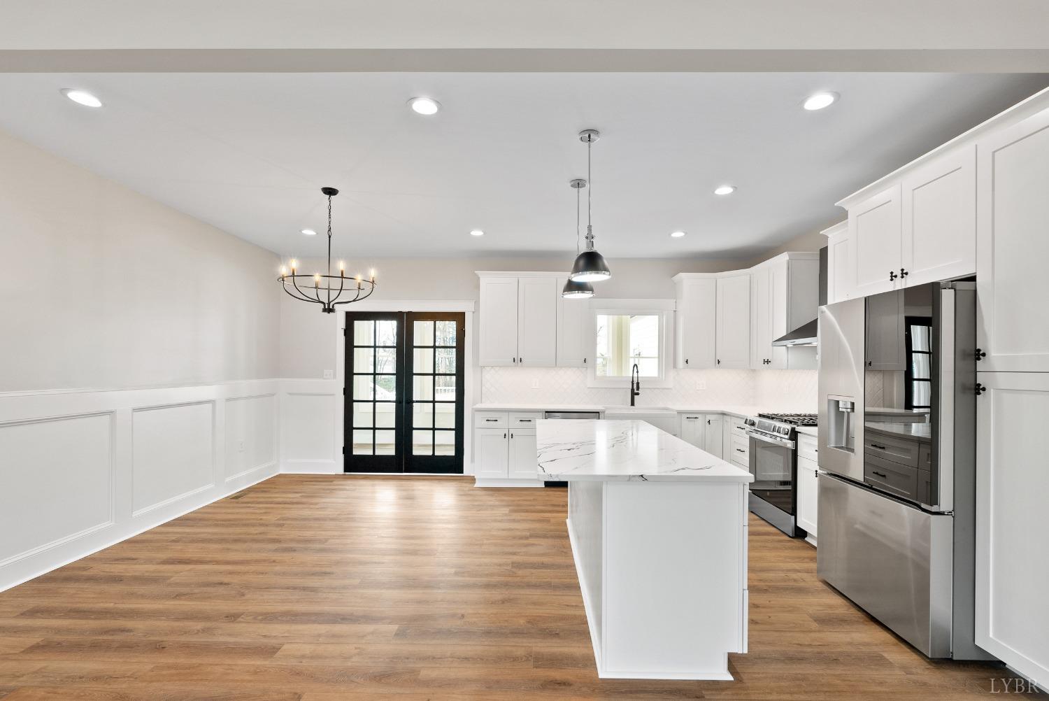 62 Burrell Drive Rustburg, VA 24588 - Photo 24 of 63 a large kitchen with stainless steel appliances kitchen island a large counter top and a wooden floors