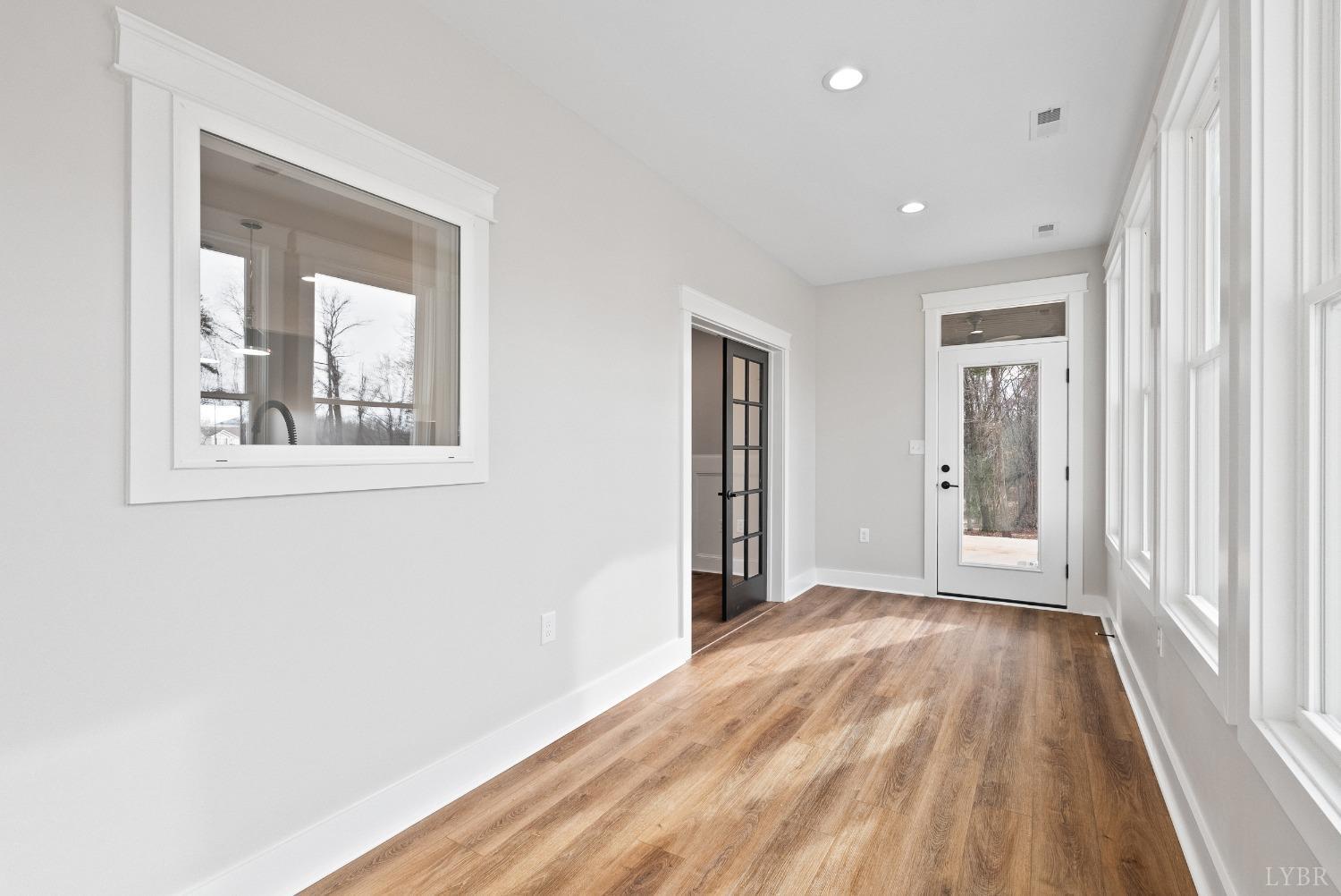 62 Burrell Drive Rustburg, VA 24588 - Photo 52 of 63 a view of an empty room with wooden floor and a window