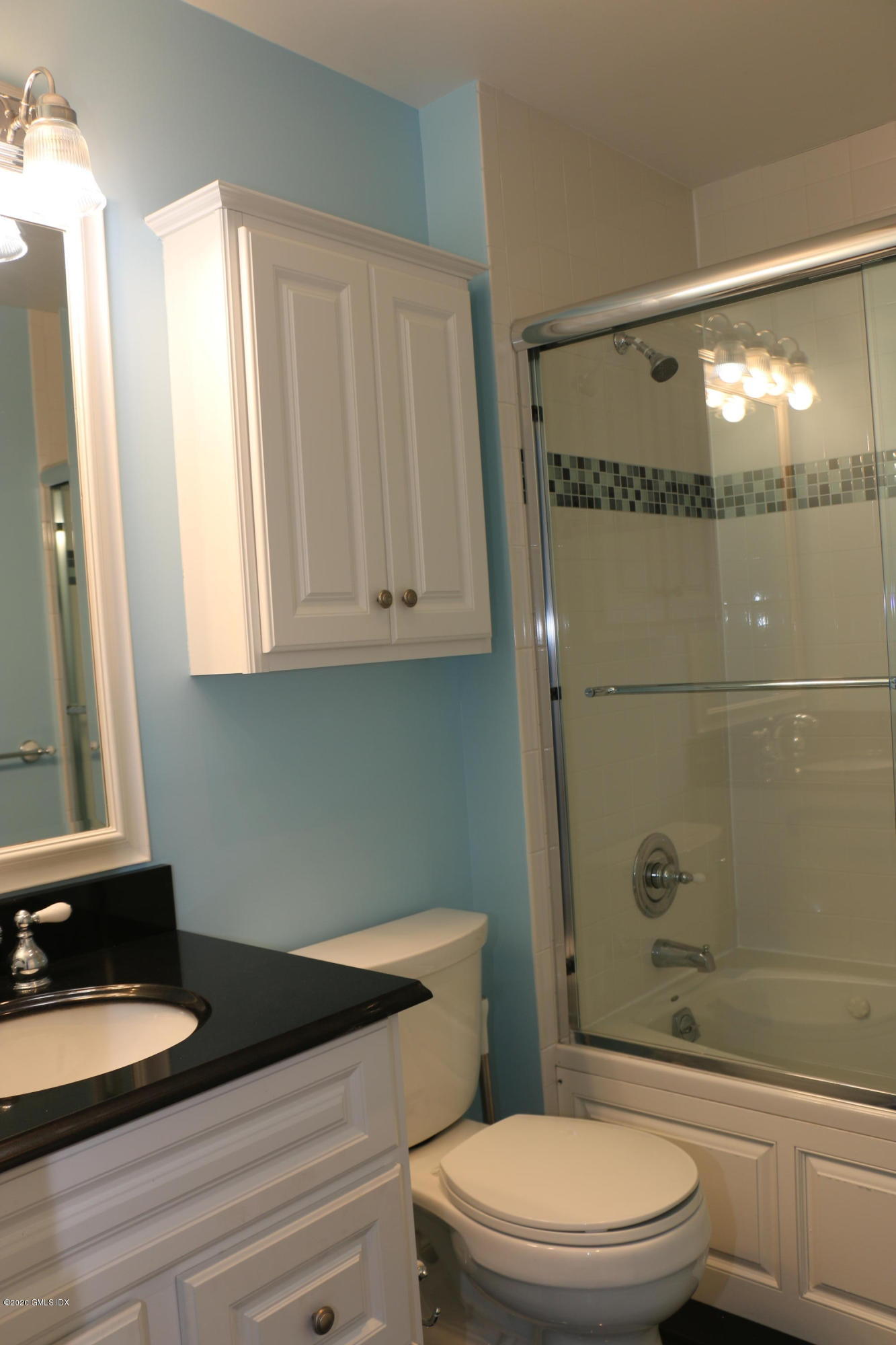 11 River Road, Unit 114 Cos Cob, CT 06807 - Photo 13 of 21 a bathroom with a granite countertop sink toilet a mirror and shower