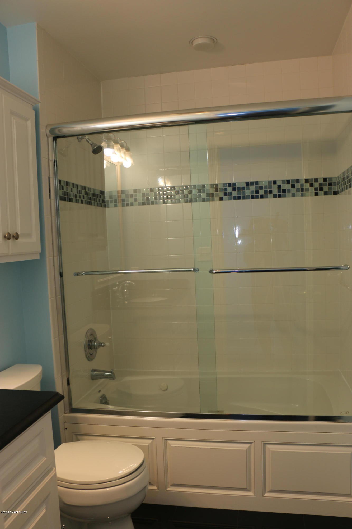 11 River Road, Unit 114 Cos Cob, CT 06807 - Photo 15 of 21 a bathroom with a toilet a sink and shower