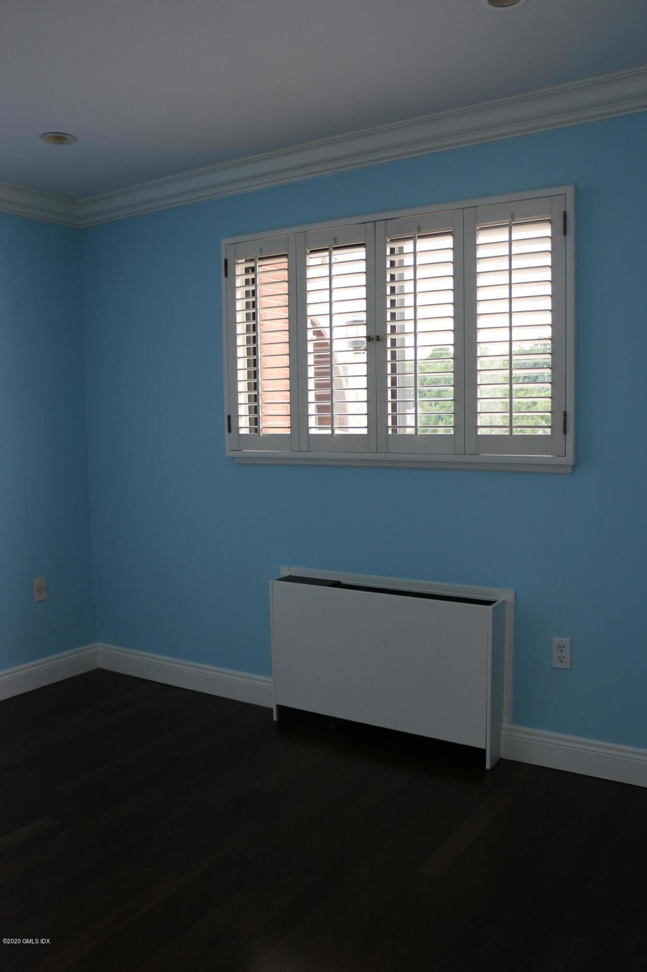 11 River Road, Unit 114 Cos Cob, CT 06807 - Photo 18 of 21 a view of a room with wooden floor and a window