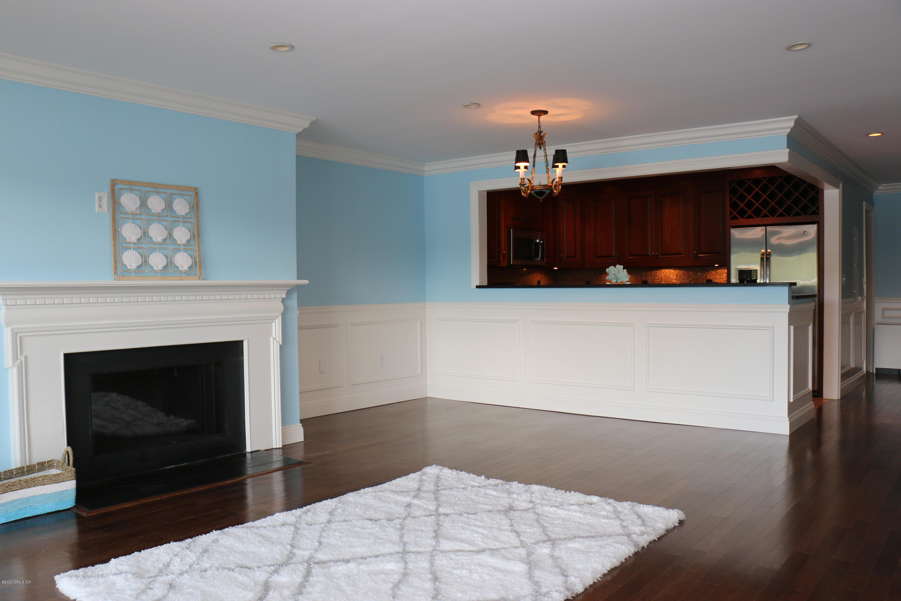 11 River Road, Unit 114 Cos Cob, CT 06807 - Photo 4 of 21 a living room with furniture and a fireplace