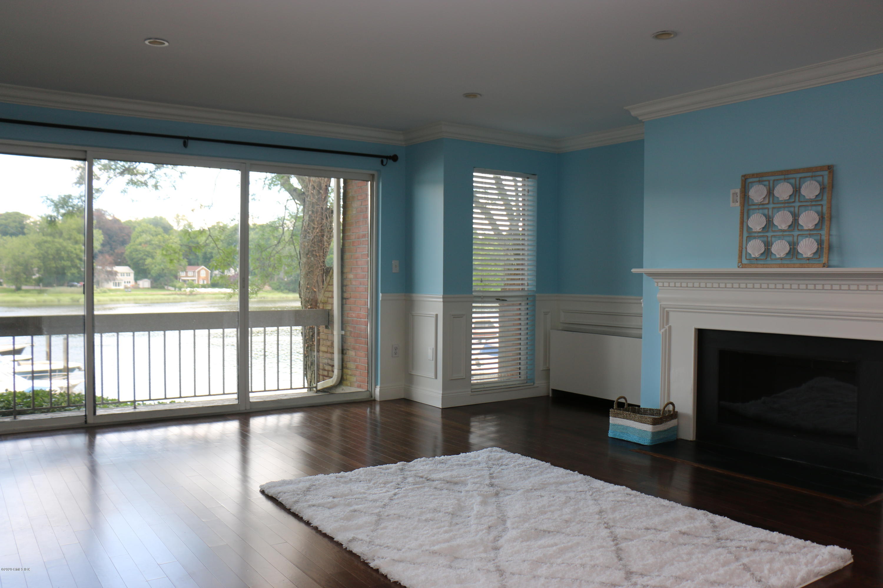 11 River Road, Unit 114 Cos Cob, CT 06807 - Photo 5 of 21 a living room with hardwood floor and a fireplace
