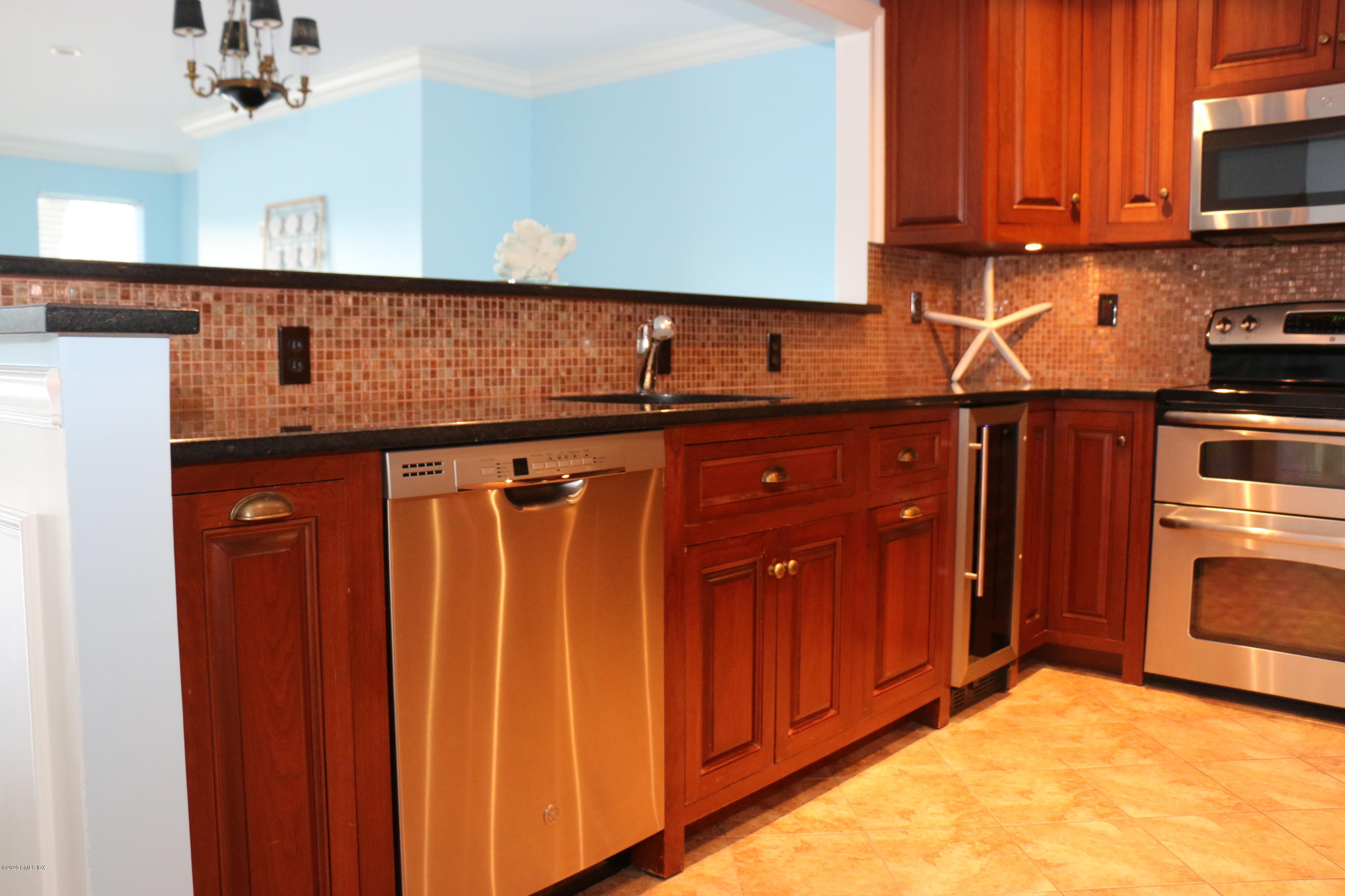 11 River Road, Unit 114 Cos Cob, CT 06807 - Photo 6 of 21 a kitchen with stainless steel appliances a refrigerator and cabinets