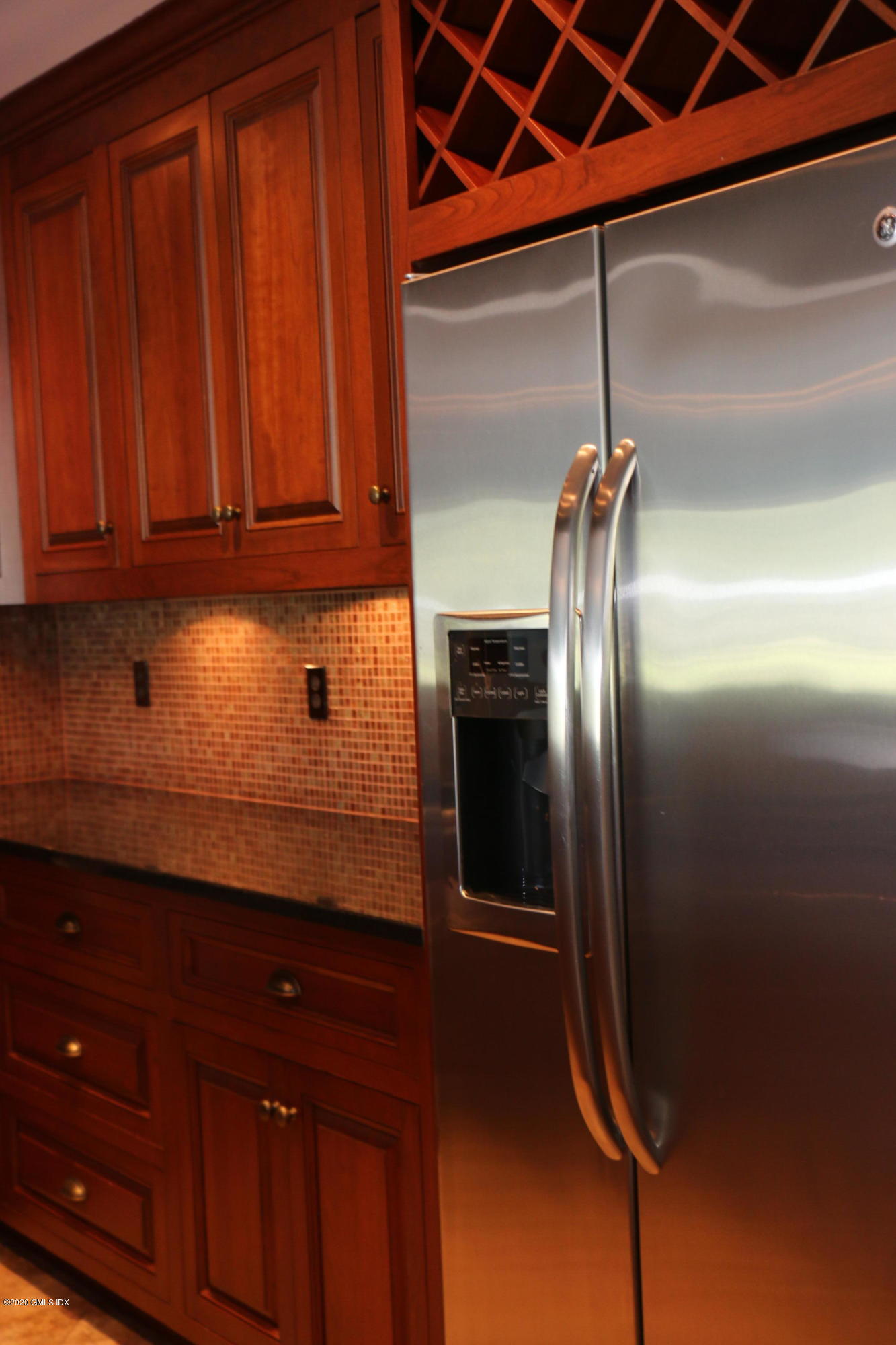 11 River Road, Unit 114 Cos Cob, CT 06807 - Photo 9 of 21 a kitchen with stainless steel appliances granite countertop a refrigerator a sink and dishwasher