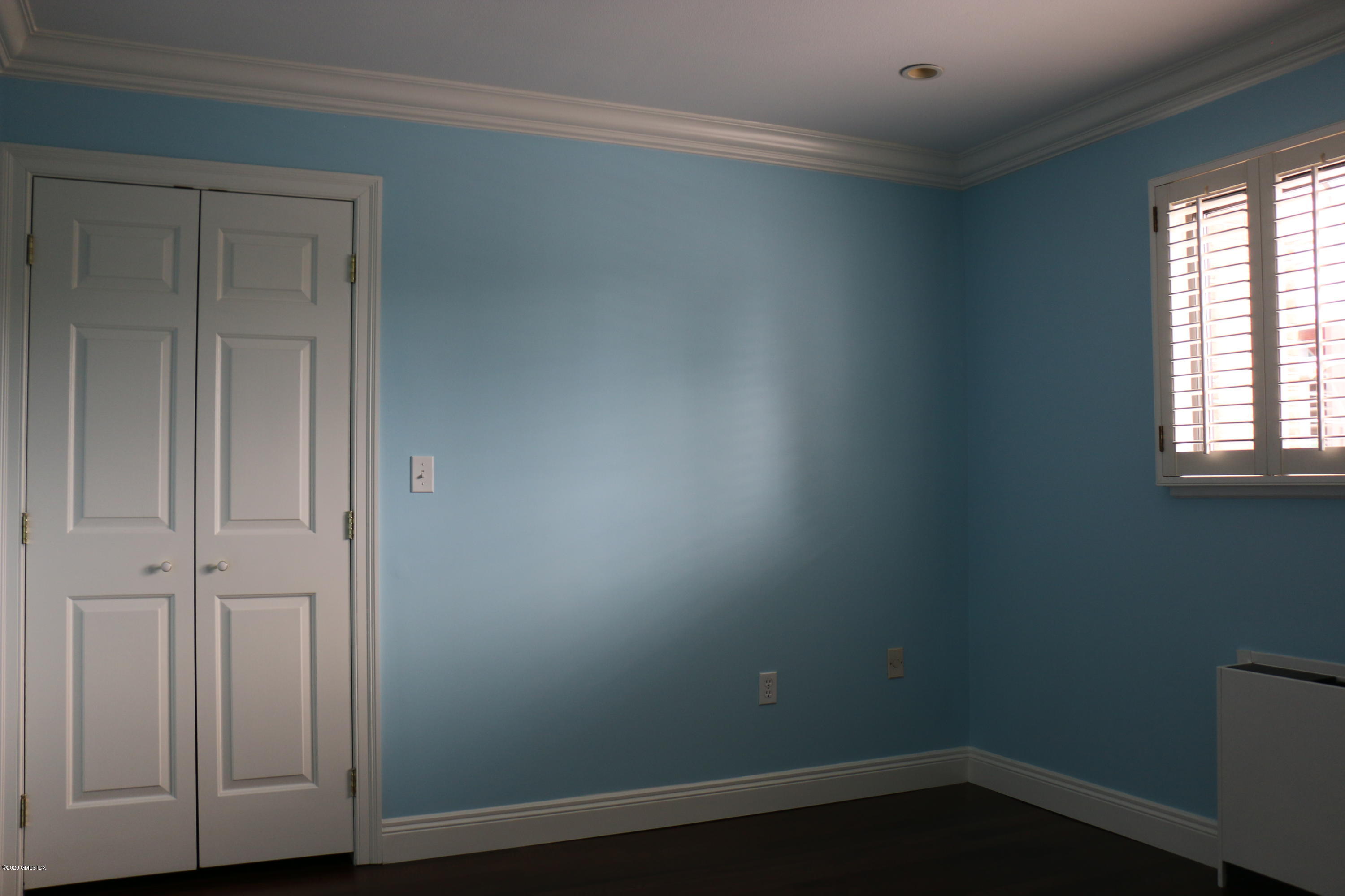 11 River Road, Unit 114 Cos Cob, CT 06807 - Photo 10 of 21 an empty room with wooden floor and window