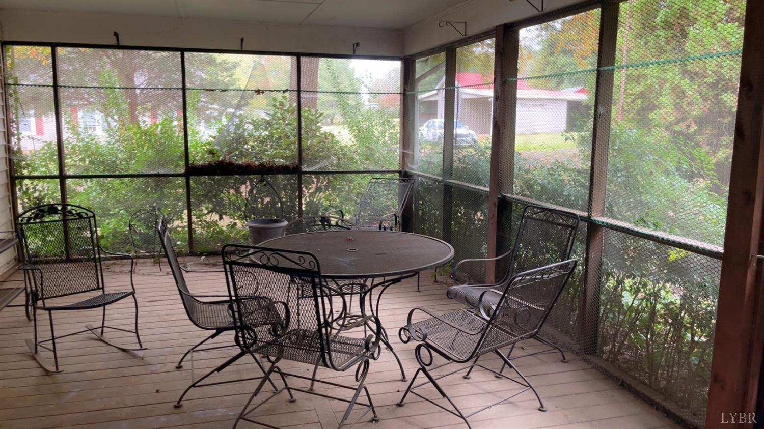 308 Randolph Street Phenix, VA 23959 - Photo 12 of 20 a view of a balcony with chairs and wooden floor