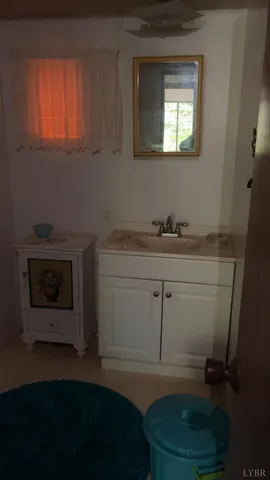 a bathroom with a sink a toilet and a window