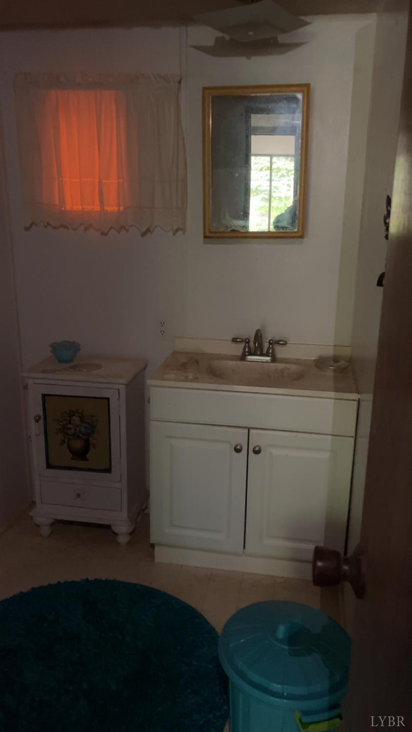 308 Randolph Street Phenix, VA 23959 - Photo 13 of 20 a bathroom with a sink a toilet and a window