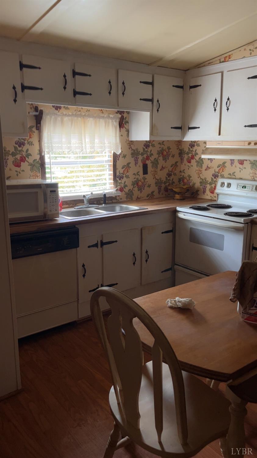 308 Randolph Street Phenix, VA 23959 - Photo 19 of 20 a kitchen with a table chairs sink and cabinets
