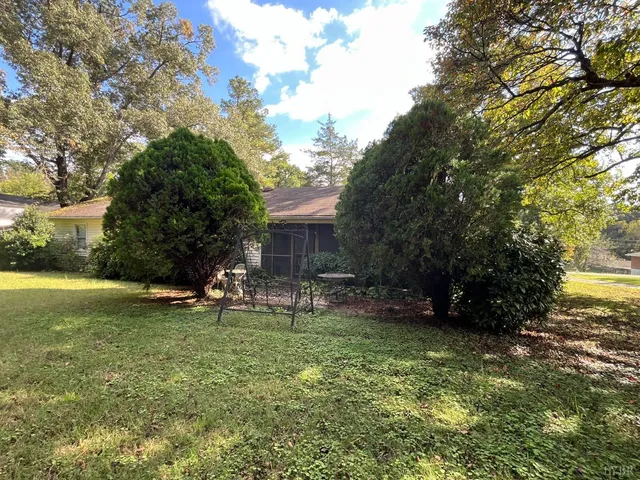 a view of a house with a yard and sitting area