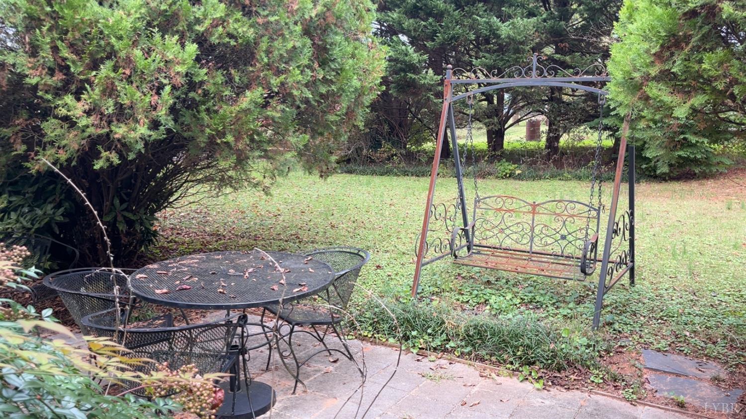 308 Randolph Street Phenix, VA 23959 - Photo 8 of 20 a view of backyard with table and chairs and a large tree