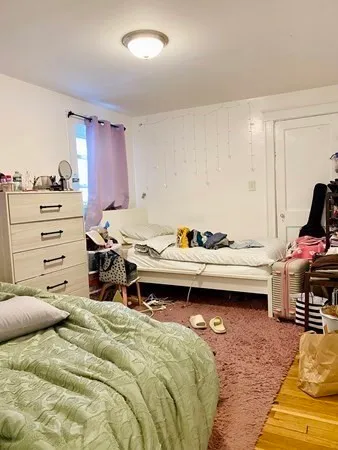 a bedroom with a bed and a table in it