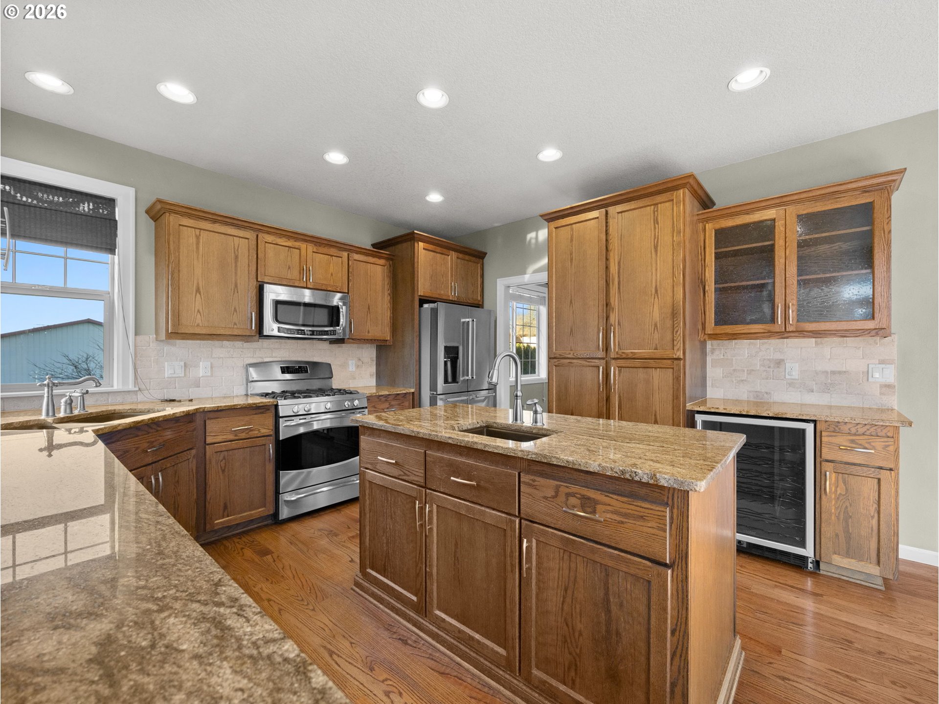 40192 Laurel Street Sandy, OR 97055 - Photo 12 of 37 a kitchen with stainless steel appliances granite countertop a sink stove microwave and refrigerator