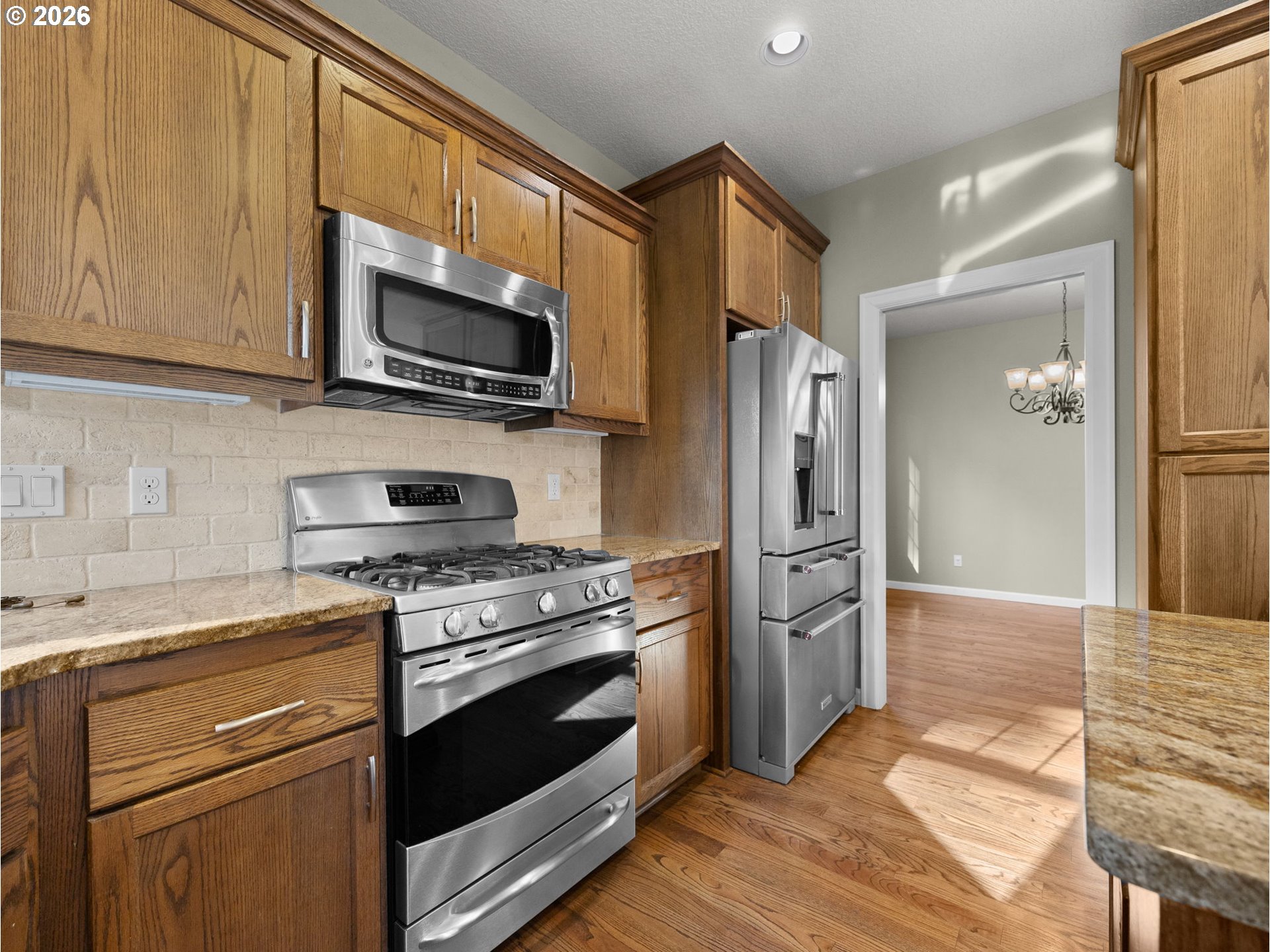 40192 Laurel Street Sandy, OR 97055 - Photo 13 of 37 a kitchen with stainless steel appliances granite countertop a stove microwave and refrigerator