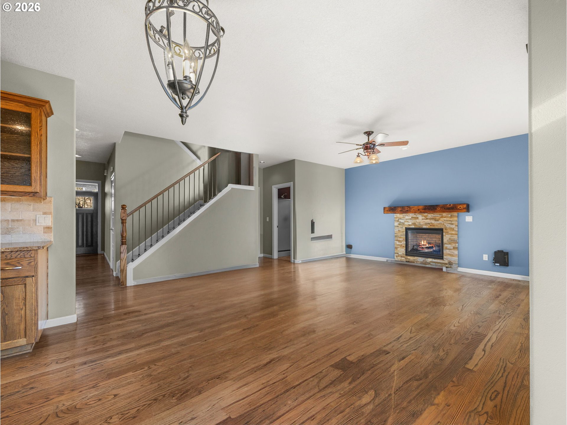 40192 Laurel Street Sandy, OR 97055 - Photo 6 of 37 a view of an empty room with wooden floor and a chandelier