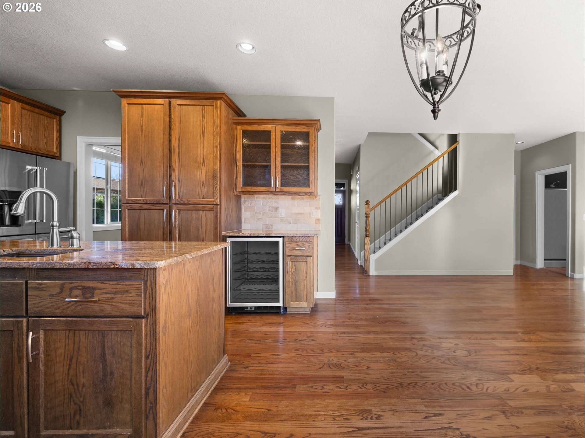 40192 Laurel Street Sandy, OR 97055 - Photo 9 of 37 a kitchen with stainless steel appliances granite countertop a refrigerator a sink dishwasher and a stove with wooden floor