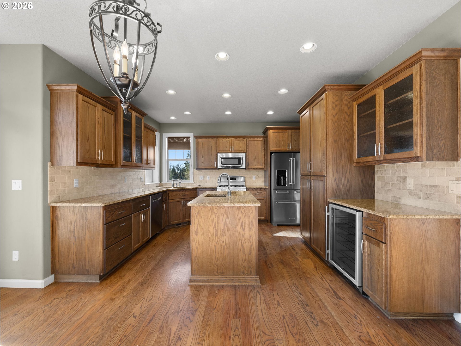 40192 Laurel Street Sandy, OR 97055 - Photo 10 of 37 a large kitchen with stainless steel appliances granite countertop a large center island a stove a refrigerator cabinets and living room view
