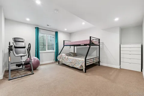 a bedroom with a bed and a chair