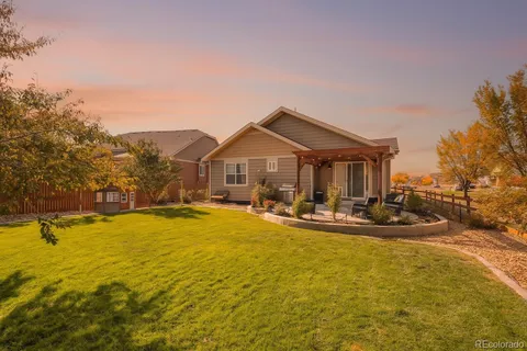 a view of a house with swimming pool and sitting area