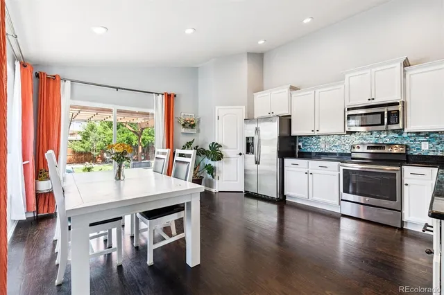 a kitchen with stainless steel appliances stove microwave and wooden floor
