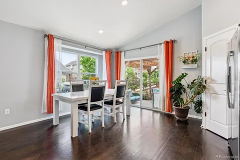 a dining room with furniture window and wooden floor