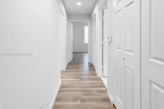a view of a bathroom with wooden floor