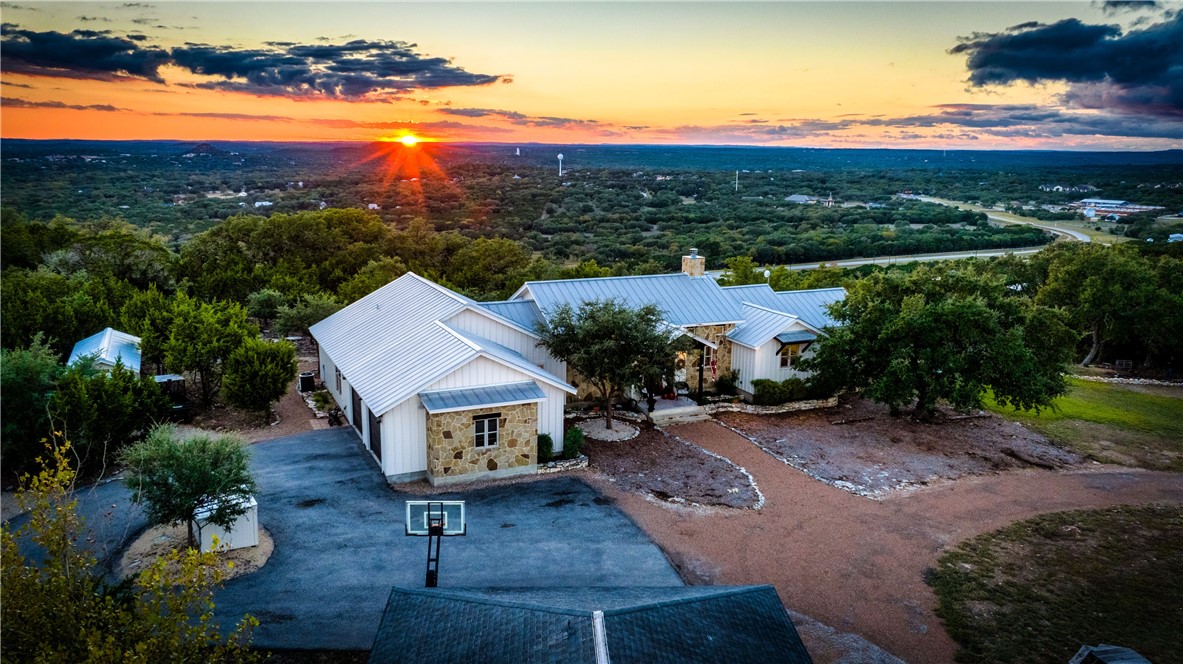 1599 Caliche Road Wimberley, TX 78676 - Photo 1 of 1 As the sun is setting over the hills.