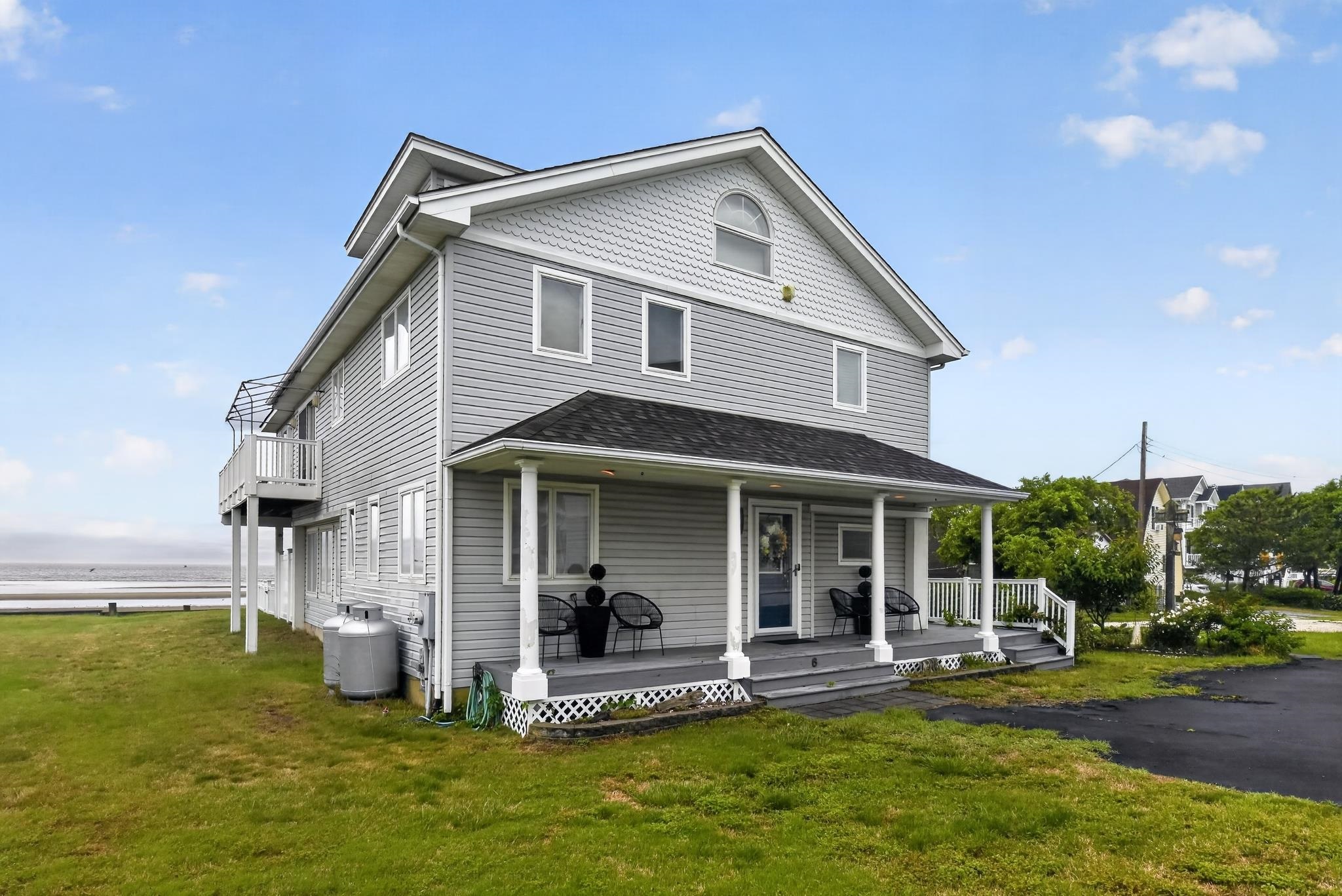 6 Pierces Point Road Cape May Court House, NJ 08210 - Photo 1 of 30 a front view of a house with a yard table and chairs