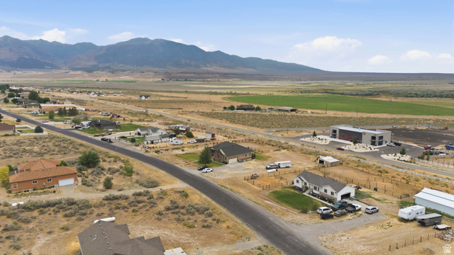 2567 West Rim Rock Drive Stockton, UT 84071 - Photo 61 of 64 Expansive rural landscape featuring distant mountains, open fields, and scattered residential properties