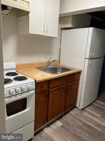 a kitchen with a stove and a refrigerator