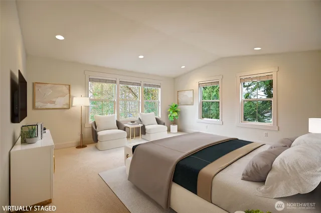 a bedroom with furniture and a large window