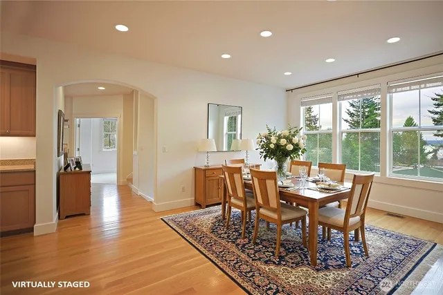 a view of a dining room with furniture window and wooden floor