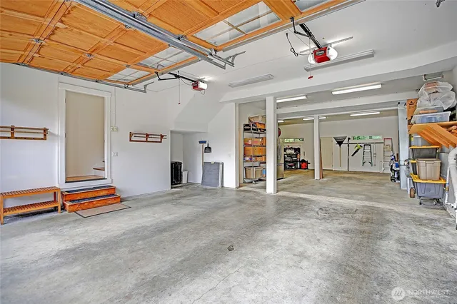 a view of empty room with stairs and mirrors