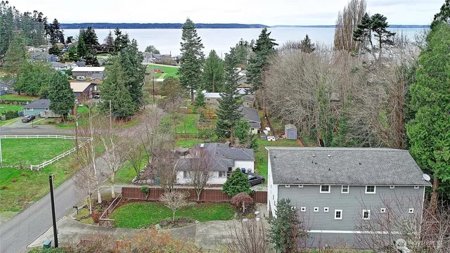 an aerial view of a house with a yard and lake view